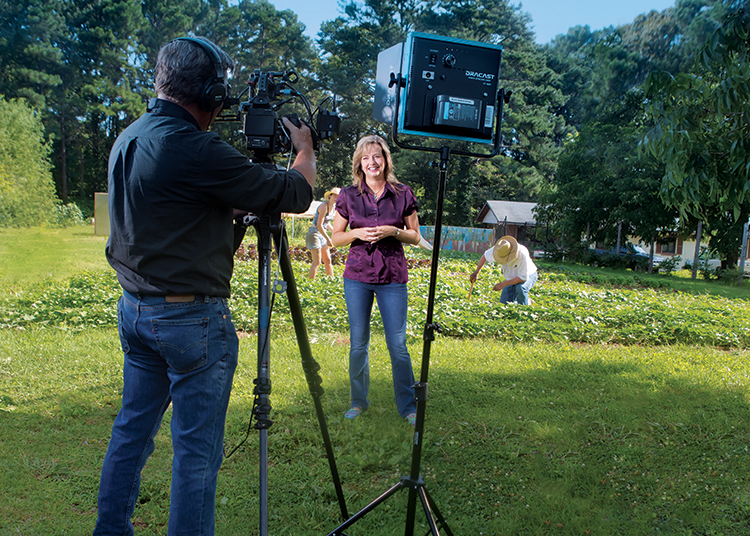 David Dalton, owner of BlueWater Media, films Lisa Prince as she hosts Flavor, NC at an urban garden in Raleigh, N.C.