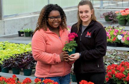 Marshall FFA members QuNaya Falls and Regan Godsey learn about floriculture in their school’s nursery. The Marshall FFA chapter received the National Model of Excellence Award, the highest award given by the National FFA Organization, beating out more than 7,700 chapters across the country.