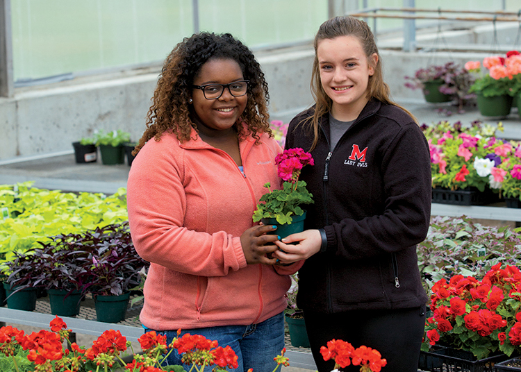 Marshall FFA members QuNaya Falls and Regan Godsey learn about floriculture in their school’s nursery. The Marshall FFA chapter received the National Model of Excellence Award, the highest award given by the National FFA Organization, beating out more than 7,700 chapters across the country.