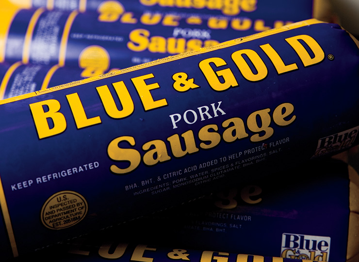 Blue and Gold Sausage Bringing Home the Bacon Farm Flavor