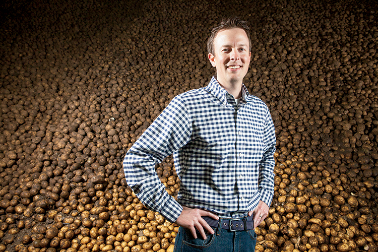 Steve Gangwish, vice president of CSS Farms, stands in front of thousands of potatoes being stored in one of several temperature controlled facilities at various CSS locations.