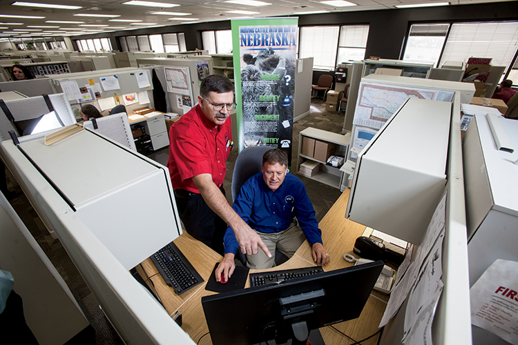 Steve Gramlich, left, and Ross Baker review import orders at the Nebraska Department of Agriculture’s Animal and Plant Health Protection Area.