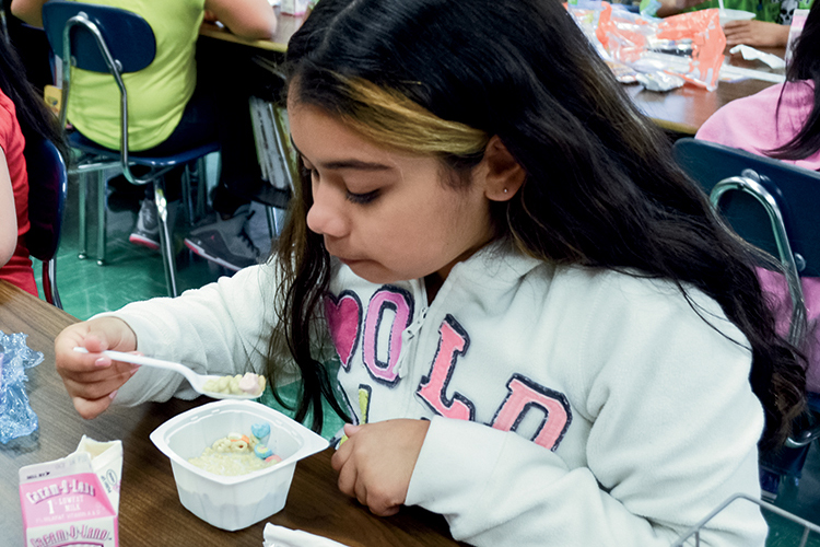 Lafayette Elementary School – fourth grader eating breakfast in the classroom 