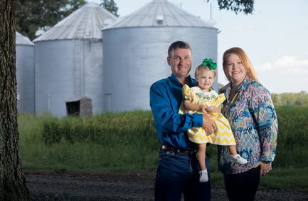 Jarrett Gurley with daughter Kemmer at their farm in Biscoe, Arkansas.
