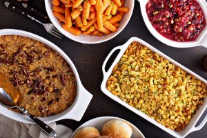 All traditional Thanksgiving side dishes, roasted carrots, sweet potato casserole, cranberry sauce and stuffing