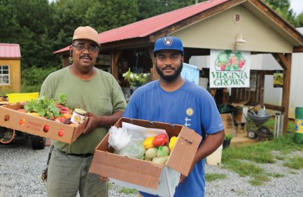 Two man with boxes of produce from Browntown Farm
