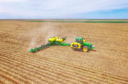 Tractor harvesting a corn field