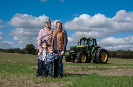 Adam and Ashley Cook with their children, Blakely and Rye, on their watermelon farm in Trenton.