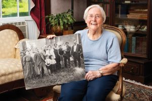 Eleanor Arnold holds a black and white photo of the Arnold family