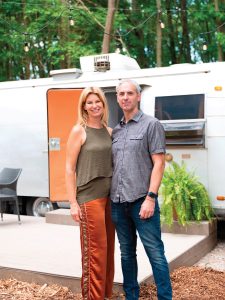 Eric and Julie Haberichter in front of one of the camper spots at their bed and breakfast, Goldberry Woods