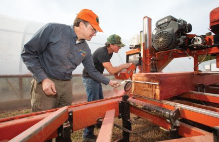 Kyle Leech, right, learns to use a portable sawmill as Adam Taylor instructs him during a class at the Cul2vate farm at the Ellington Agricultural Center in Nashville.