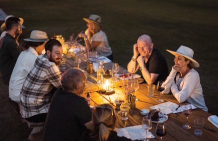 Visitors at Zapata Ranch, a Colorado agritourism destination, gather for an evening dinner outside