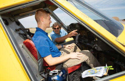 Student Ian McMahen sits in an air tractor as instructor Ike Brunetti shows him the controls at Delta State Universitys Flight School in Cleveland. ©Journal Communications/