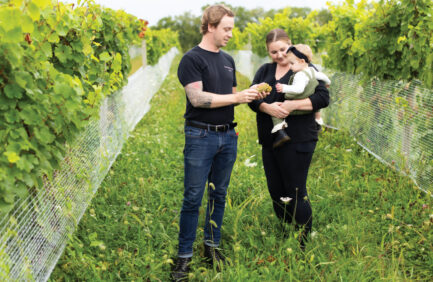 Maxx Eichberg and Sidney Finan with their daughter Billie at their Michigan vineyard