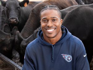 Former NFL linebacker Avery Williamsons surrounded by his cows on the family farm in Milan, Tennessee.