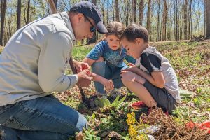 Jack Barrett shares the tradition of forest care by teaching his stepdaughter, Lylah Rhodes, and nephew, Lochlan Alley, how to plant saplings on their family farm. tree farming