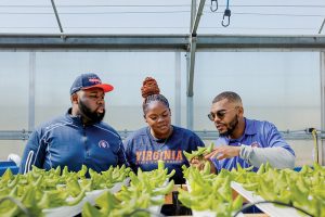 Students with an educator in one of the greenhouses at Virginia State University College of Agriculture