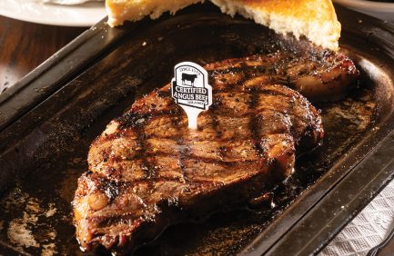 Grilled steak with visible sear marks and a label