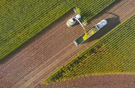 aerial view of a combine harvester in a farm field